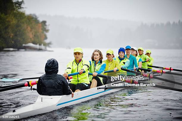 mature women rowing eight person rowing shell - coxed rowing stock pictures, royalty-free photos & images