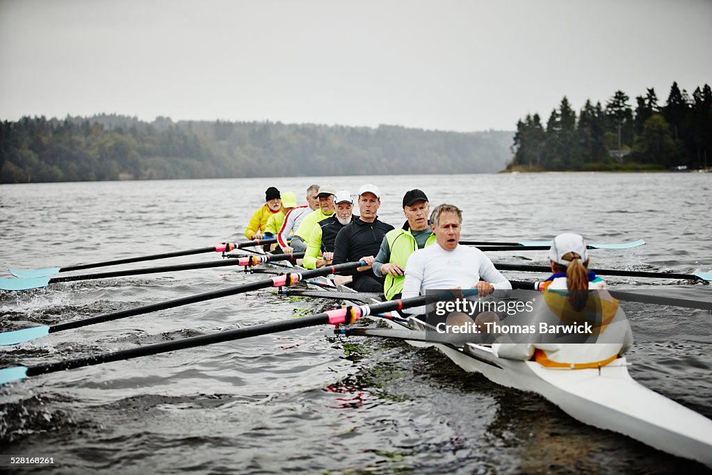 Mature men rowing eight person rowing shell