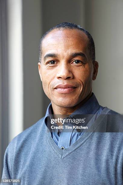 portait of confident black man - portrait of man smiling black jumper stock-fotos und bilder