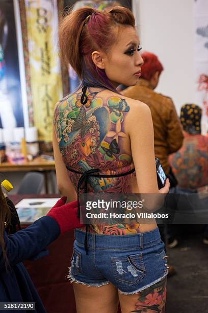 Tattoo covers in full the back of one of the Asian tattoo models, at the 21st International Tattoo-Convention in Frankfurt, Germany, 22 March 2013....