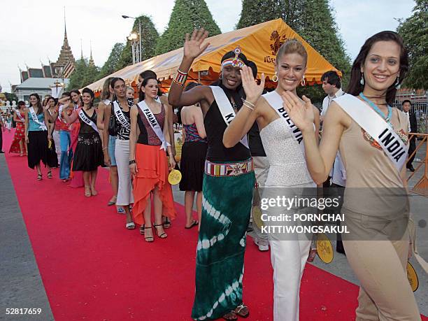 Miss India Amrita Thapar and Miss Universe 2005 contestants waves while walk on red carpet during a parade in front of the Grand Royal palace in...