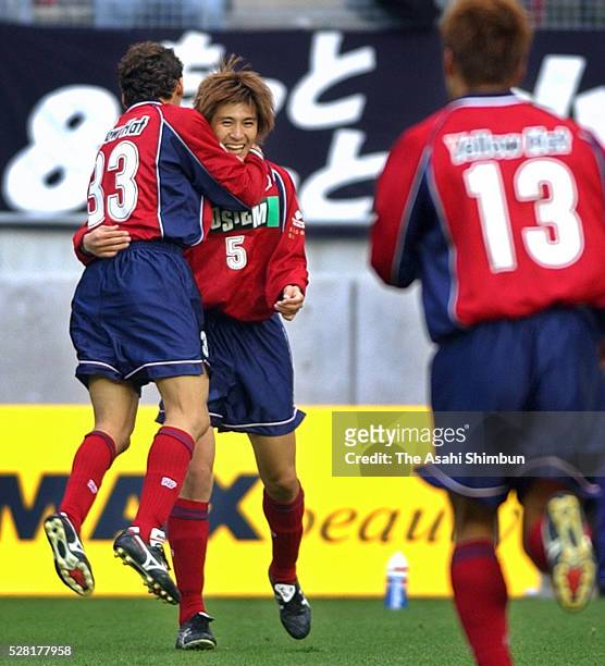 Koji Nakata of Kashima Antlers celebrates scoring his team's first goal with his team mate Augusto during the J.League match between Kashima Antlers...