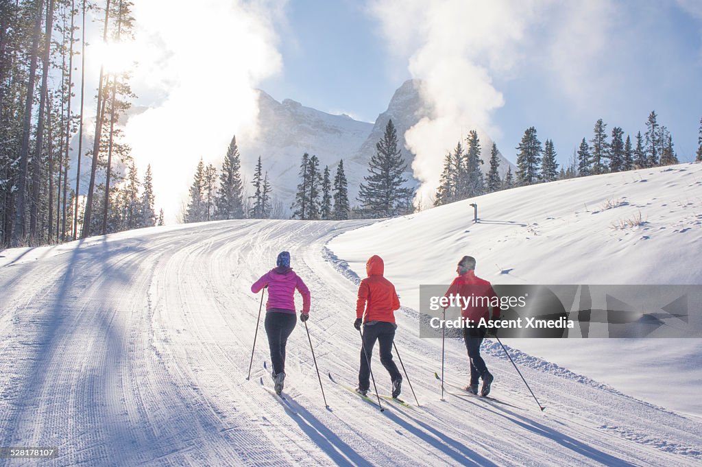 Nordic skiers ascend ski track on very cold day