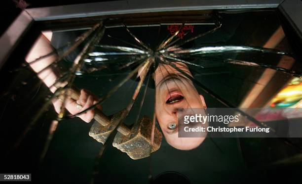 Andrew McDonald of Edinburgh Dungeon smashes a mirror with a mallet to dispel the superstition of seven years bad luck on May 13, 2005 in Edinburgh,...