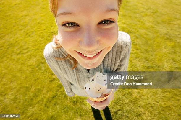 young girl eating ice cream cone - girl eating messy ice cream cone stock-fotos und bilder