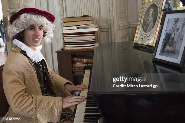 Niccolo Antonelli of Italy and Ongetta Rivacold plays the piano during a preview event at the Chateau du Lude ahead of the MotoGp of France, on May...
