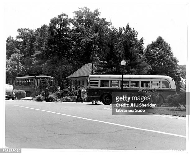 Landscape shot of buses on the street, Roland Park/Guilford, Baltimore, Maryland, 1910. This image is from a series documenting the construction and...