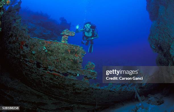scuba diver exploring sunken ship - scuba regulator stock pictures, royalty-free photos & images