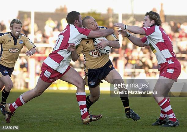 Andrew Dunemann of Leeds is tackled by Jason Kent of Leigh during the Engage Super League match between Leigh Centurions and Leeds Rhinos at the...