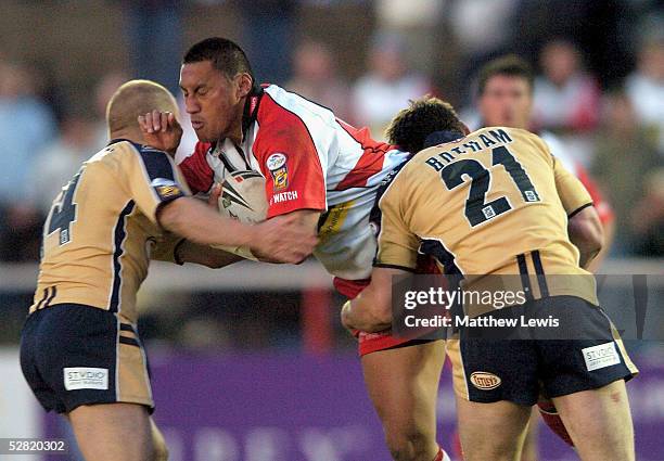 Dom Feaunati of Leigh is tackled by Andrew Dunemann and Liam Botham of Leeds during the Engage Super League match between Leigh Centurions and Leeds...