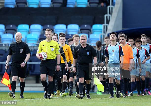 Referee Mike Jones leads the teams out during the under 16 Schools' Cup final match between Thomas Telford School and Samuel Whitbread Academy at the...