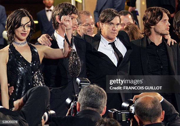 Italian actress Asia Argento raises her fist as she poses for photographers with co-stars US actor Lukas Haas, US director Gus Van Sant and US actor...