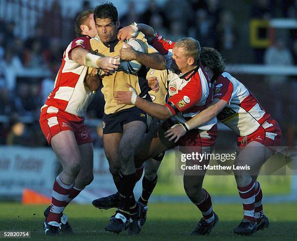 Leigh players try to stop Chris McKenna of Leeds during the Engage Super League match between Leigh Centurions and Leeds Rhinos at the Coliseum...