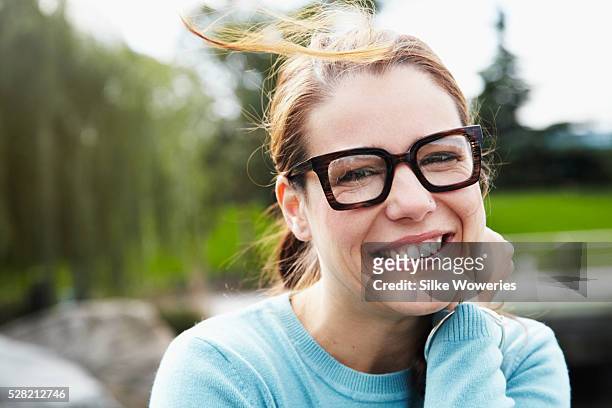 portrait of woman relaxing in park - lady 30s wearing glasses stock pictures, royalty-free photos & images