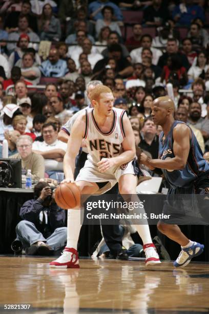 Brian Scalabrine of the New Jersey Nets is defended by Anthony Peeler of the Washington Wizards during the game on April 17, 2005 at the Continental...