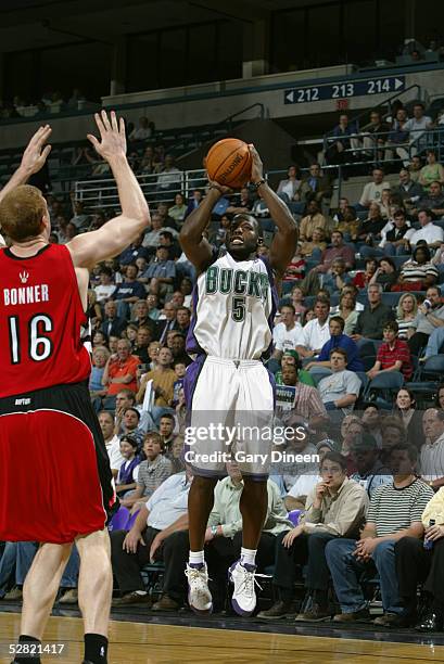 Anthony Goldwire of the Milwaukee Bucks shoots over Matt Bonner of the Toronto Raptors during the game on April 19, 2005 at the Bradley Center in...
