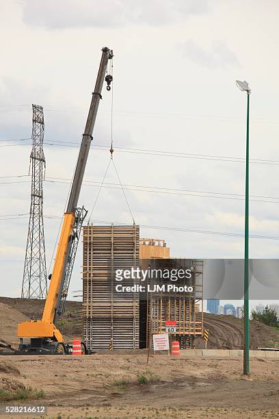 crane putting concrete form in place for bridge construction - stack_interchange stock pictures, royalty-free photos & images