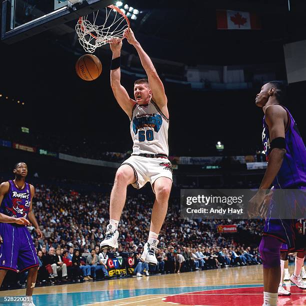 Bryant Reeves of the Vancouver Grizzlies dunks against the Toronto Raptors during the NBA game on January 19, 1997 in Vancouver, British Colmbia,...