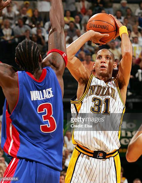 Reggie Miller of the Indiana Pacers shoots against Ben Wallace of the Detroit Pistons in Game three of the Eastern Conference Semifinals during the...