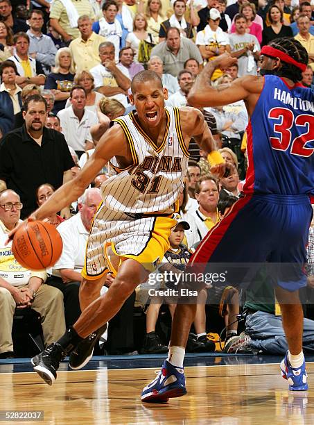 Reggie Miller of the Indiana Pacers drives against Richard Hamilton of the Detroit Pistons in Game three of the Eastern Conference Semifinals during...