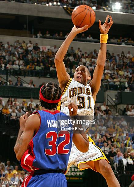 Reggie Miller of the Indiana Pacers shoots over Richard Hamilton of the Detroit Pistons in Game three of the Eastern Conference Semifinals during the...