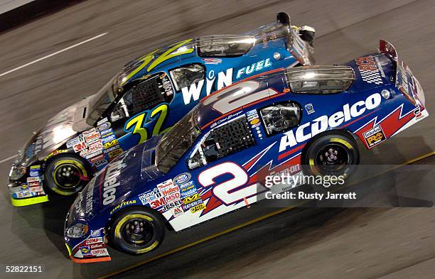 Clint Boyer, driver of the AC Delco Chevrolet, races with Shane Hmiel, driver of the Win Fuel Chevrolet, during the NASCAR Busch Series Funai 250 on...