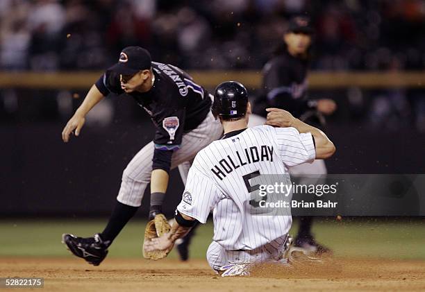 Matt Holliday of the Colorado Rockies steals second base in front of the throw to second baseman Alex Cintron of the Arizona Diamondbacks in the...