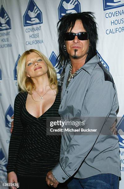 Actress Donna D'Errico and Motley Crue bassist Nikki Sixx arrive at the Covenant House California Youth Dinner at the Beverly Hilton Hotel on May 13,...