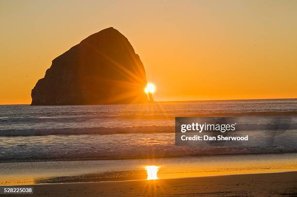 sunburst and haystack rock at cape kiwanda - tillamook rock light stock pictures, royalty-free photos & images