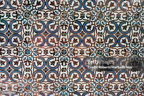 Old tiles in Spanish colonial house architecture. Vintage floor tiles with black, and blue as a decorative design.