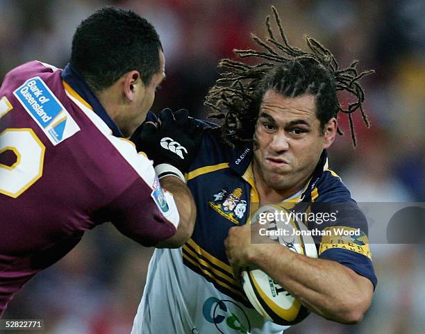 George Smith of the Brumbies fends off a tackle during the Super 12 match between the Queensland Reds and ACT Brumbies at Suncorp Stadium on May 14,...