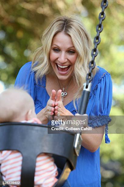 a mother playing with her baby in a swing - joy gresham fotografías e imágenes de stock