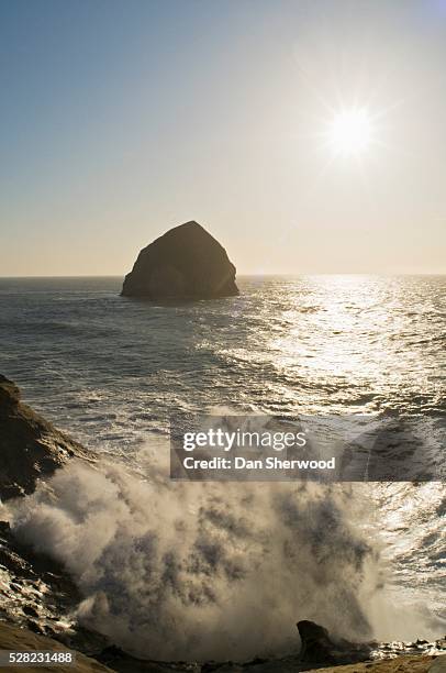 haystack rock and crashing surf at cape kiwanda - tillamook rock light stock pictures, royalty-free photos & images