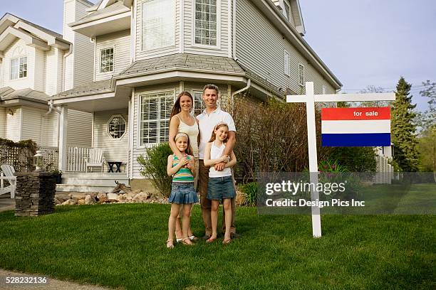 family standing in front of house for sale - couple archival stock pictures, royalty-free photos & images