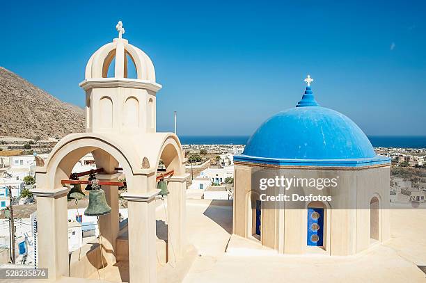 church with blue dome roof and view of the aegean sea; megalochori, santorini, greece - megalochori stock-fotos und bilder