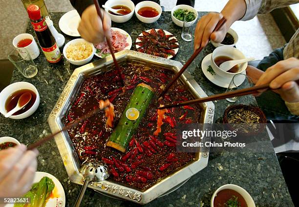 Chinese people eat "Hot Pot" at a restaurant on May 13, 2005 in Chengdu of Sichuan Province, China. "Hot Pot", a soup base and dipping sauce, is the...