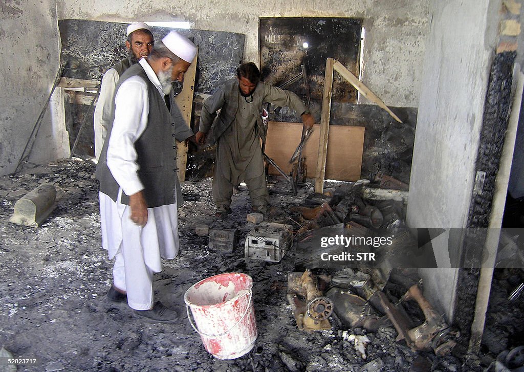 Afghan men clear their office at the Afg