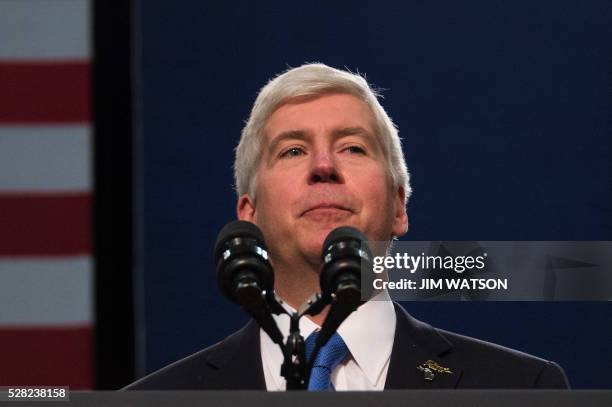 Michigan Governor Rick Snyder pauses as he is booed by the audience, as he speaks at Flint Northwestern High School in Flint, Michigan, May 4 where...