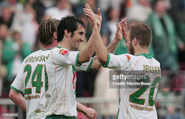 Johan Micoud and Daniel Jensen of Bremen celebrates the fourth goal during the Bundesliga match between Werder Bremen and SC Freiburg at the Weser...