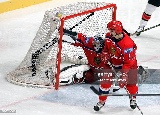 Goalkeeper Maxim Sokolov of Russia misses the save on a shot by Ed Jovanovski of Canada as Denis Denisov watches the play in the second period of the...