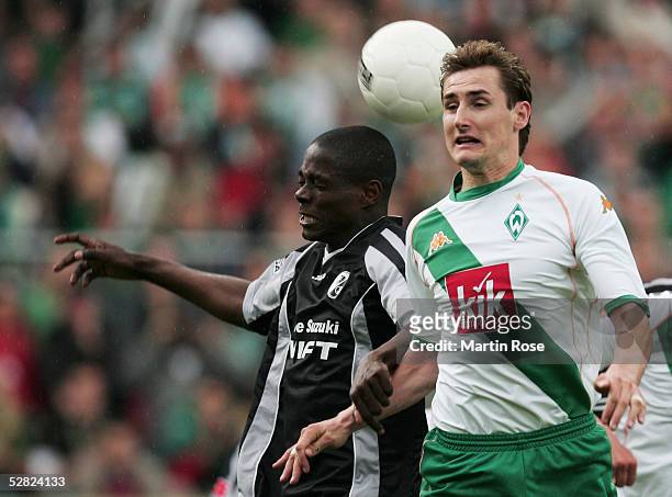 Miroslav Klose of Bremen challenges Sheyi Olajengbesi of Freiburg during the Bundesliga match between Werder Bremen and SC Freiburg at the Weser...