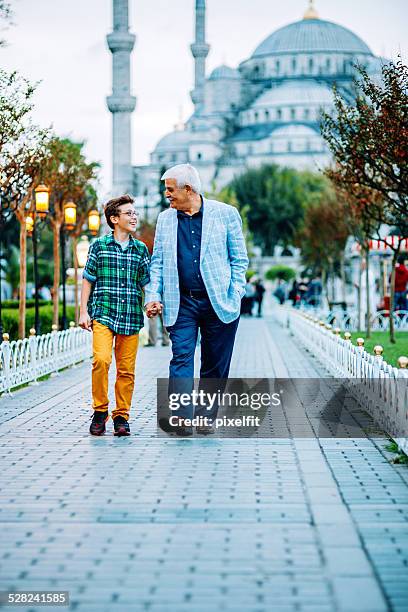 senior man and little boy walking in istanbul - istanboel europese deel stockfoto's en -beelden