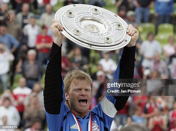Oliver Kahn of Munich raises the trophy after the Bundesliga match between FC Bayern Munich and 1. FC Nuremberg at the Olympic Stadium on May 14,...