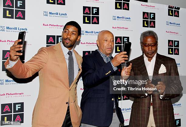 Fonzworth Bentley, Russell Simmons and Ed Lewis Snapchat on the carpet at Russell Simmons' Rush Philanthropic Arts Foundation's Inaugural Art For...