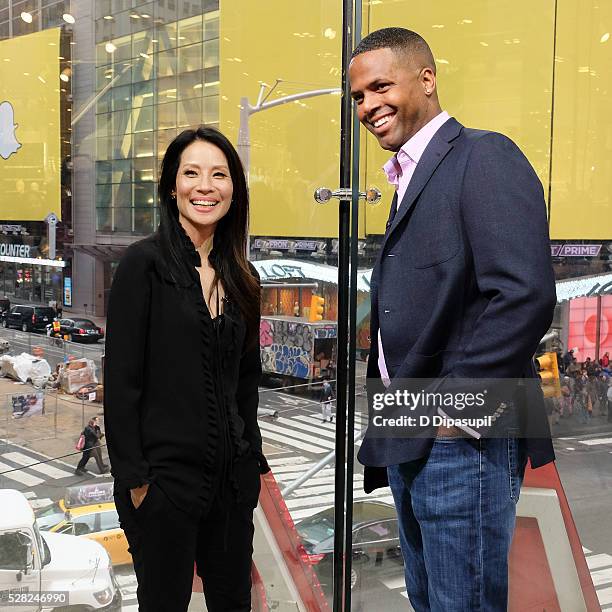 Calloway interviews Lucy Liu during her visit to "Extra" at their New York studios at H&M in Times Square on May 4, 2016 in New York City.