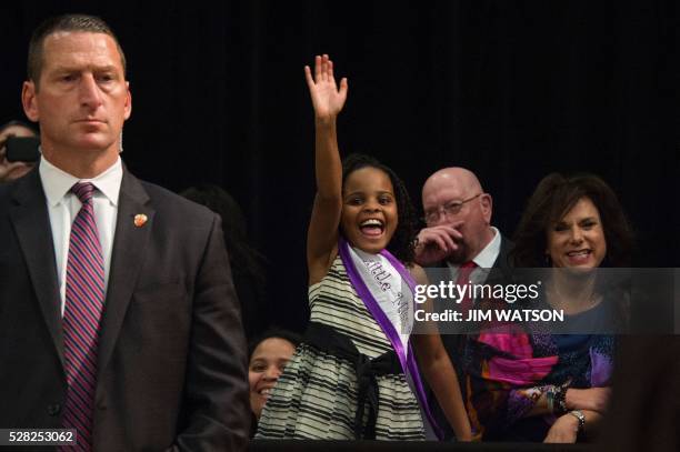 "Little Miss Flint" Mari Copeny waves during an event at Northwestern High School in Flint, Michigan, May 4 where US President Barack Obama met with...