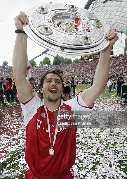 Bixente Lizarazu of Munich raises the trophy after the Bundesliga match between FC Bayern Munich and 1. FC Nuremberg at the Olympic Stadium on May...