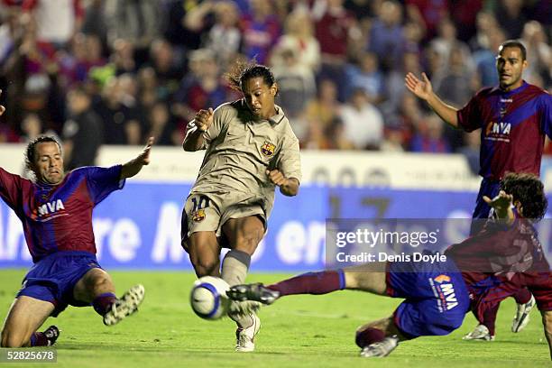 Barcelona`s Ronaldinho shoots at goal while under pressure from two Levante players during a La Liga match between Levante and Barcelona at the...