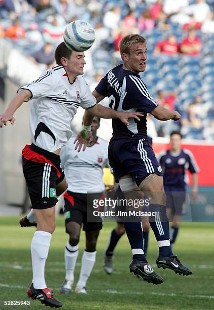 Taylor Twellman of the New England Revolution heads the ball away from Bobby Boswell of D.C. United during their game at Gillette Stadium on May 14,...