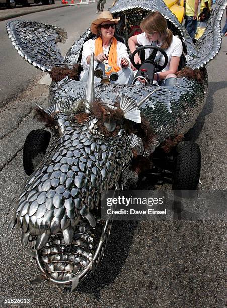 Anne Owen and Abigail Owen-Pontez strap into "Elee", a car made of cutlery from American Airlines during the Everyones Art Car Parade May 14, 2005 in...